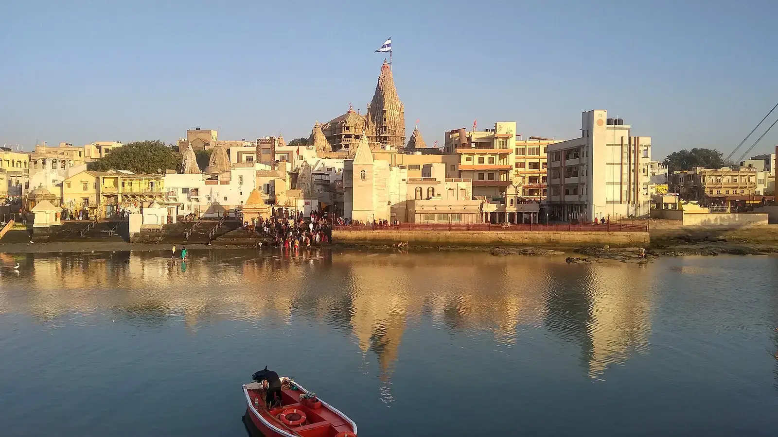 The Dwarkadhish temple spire over the town, reflected in the Gomti